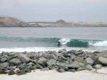 Boogie boarding in front of Tiki Tano (note wetsuits!)